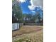 Large, grassy backyard with wooden fence, storage shed, and mature trees at 4457 Webb Meadows Dr, Loganville, GA 30052