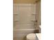 Bathroom with shower-tub combo featuring a white shower surround and neutral walls at 4457 Webb Meadows Dr, Loganville, GA 30052