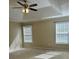 Bedroom featuring a tray ceiling with ceiling fan, and natural light at 4457 Webb Meadows Dr, Loganville, GA 30052