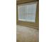 Bright bedroom featuring a window with horizontal blinds and neutral carpeting at 4457 Webb Meadows Dr, Loganville, GA 30052