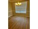 Empty Dining Room with wood flooring, a modern chandelier, and natural light at 4457 Webb Meadows Dr, Loganville, GA 30052
