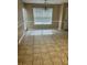 Open dining area featuring tiled flooring, a window with blinds, and an overhead light fixture at 4457 Webb Meadows Dr, Loganville, GA 30052