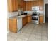 Functional kitchen with wood cabinets, white appliances, and neutral countertops at 4457 Webb Meadows Dr, Loganville, GA 30052