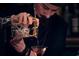 Well dressed bartender pours a drink in a glass with precision at 567 Ponce De Leon Ne Ave # 312, Atlanta, GA 30308