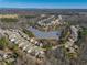 Community aerial view featuring pond and wooded areas surrounded by single-Gathering homes at 6645 Country Lake Rd, Cumming, GA 30041
