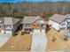 Aerial shot showcases a beautiful home with a long driveway amid well-manicured lawns at 6645 Country Lake Rd, Cumming, GA 30041