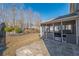 Landscaped backyard featuring a screened porch and stone patio at 6645 Country Lake Rd, Cumming, GA 30041