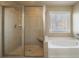 Bathroom showcasing a glass-enclosed shower and a soaking tub at 6645 Country Lake Rd, Cumming, GA 30041