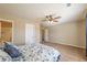 Spacious bedroom with neutral walls, ceiling fan and access to the bathroom at 6645 Country Lake Rd, Cumming, GA 30041