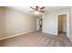 Spacious bedroom features a ceiling fan, neutral paint and carpeting, and an ensuite bathroom at 6645 Country Lake Rd, Cumming, GA 30041