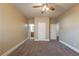 Spacious bedroom with neutral tones, carpet flooring, and multiple doorways at 6645 Country Lake Rd, Cumming, GA 30041