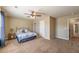 Comfortable bedroom featuring neutral walls, ceiling fan, and an en-suite bathroom at 6645 Country Lake Rd, Cumming, GA 30041