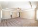 Spacious primary bedroom with trey ceiling, ceiling fan, and windows for natural light at 6645 Country Lake Rd, Cumming, GA 30041