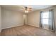 Bedroom with ceiling fan, neutral walls, carpet, and window with light-filtering shades at 6645 Country Lake Rd, Cumming, GA 30041