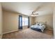 Cozy bedroom featuring a ceiling fan, neutral walls, and ample natural light at 6645 Country Lake Rd, Cumming, GA 30041