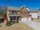 Beautiful two-story home with brick accents, a two-car garage, and a cozy front porch at 6645 Country Lake Rd, Cumming, GA 30041