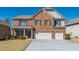 Charming two-story brick home featuring a well-manicured lawn and a two-car garage, inviting you to your dream home at 6645 Country Lake Rd, Cumming, GA 30041