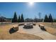 A stone fire pit with built-in seating creates a cozy outdoor gathering space at 6645 Country Lake Rd, Cumming, GA 30041