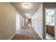 Hallway with carpet, neutral walls, and view to bathroom with double sink vanity at 6645 Country Lake Rd, Cumming, GA 30041