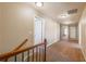 Well-lit carpeted hallway showcasing access to multiple rooms and areas of the home at 6645 Country Lake Rd, Cumming, GA 30041