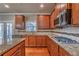 Gourmet kitchen with granite countertops, stainless appliances, and gas cooktop at 6645 Country Lake Rd, Cumming, GA 30041