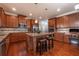 Elegant kitchen features granite countertops, stainless steel appliances and wood floors at 6645 Country Lake Rd, Cumming, GA 30041