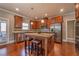 Elegant kitchen features granite countertops, stainless steel appliances and wood floors at 6645 Country Lake Rd, Cumming, GA 30041