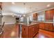 Open concept kitchen with granite island connects to living room with fireplace at 6645 Country Lake Rd, Cumming, GA 30041
