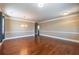 Spacious living room featuring gleaming hardwood floors, neutral wall colors, and modern lighting, creating a warm, inviting space at 6645 Country Lake Rd, Cumming, GA 30041