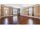 Elegant living room featuring gleaming hardwood floors, neutral wall colors, and modern lighting, creating a warm, inviting space at 6645 Country Lake Rd, Cumming, GA 30041