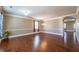 Elegant living room featuring gleaming hardwood floors, neutral wall colors, and modern lighting, creating a warm, inviting space at 6645 Country Lake Rd, Cumming, GA 30041