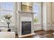 Elegant living room showcasing a fireplace with marble surround and two large windows at 1402 Downington Nw Vw, Acworth, GA 30101