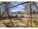 Backyard boasts a lakefront swing, lawn, and mature trees at 3093 Brookshire Way, Duluth, GA 30096