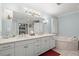 Bright bathroom features dual sinks, tub, and recessed lighting at 3093 Brookshire Way, Duluth, GA 30096
