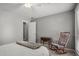 Bedroom with rocking chair by the window and a door leading to another room at 3093 Brookshire Way, Duluth, GA 30096