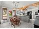 Eat-in kitchen featuring light, airy floors, white cabinets, an island, and access to the back yard at 3093 Brookshire Way, Duluth, GA 30096