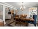 This dining room has seating for six, an elegant chandelier, and views to the living room and kitchen at 3093 Brookshire Way, Duluth, GA 30096