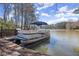 Dock featuring a pontoon boat on a serene lake at 3093 Brookshire Way, Duluth, GA 30096