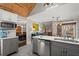 The open kitchen has gray cabinets, stainless appliances, and marble countertops at 3093 Brookshire Way, Duluth, GA 30096