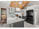 Modern kitchen features white cabinets, a breakfast bar, stainless appliances, and a wood-paneled ceiling at 3093 Brookshire Way, Duluth, GA 30096