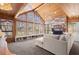 Bright living room features a wall of windows with lake views, wood-paneled ceiling, and fireplace at 3093 Brookshire Way, Duluth, GA 30096