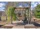 A covered outdoor lounge area, featuring two chairs and views of the lake at 3093 Brookshire Way, Duluth, GA 30096