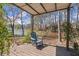 A cozy outdoor lounge area, featuring a single chair and serene views of the lake at 3093 Brookshire Way, Duluth, GA 30096