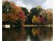 Beautiful lake view reflecting vibrant fall foliage and a peaceful waterfront setting at 3093 Brookshire Way, Duluth, GA 30096