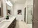 Well-lit bathroom with double sinks, a walk-in shower, and neutral-toned tile at 542 Sawnee Village Blvd # D69, Cumming, GA 30040