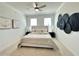 Bedroom featuring a ceiling fan and black circular decorations above the bed at 542 Sawnee Village Blvd # D69, Cumming, GA 30040