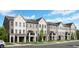 Exterior of new townhomes with light tan siding and covered balconies at 542 Sawnee Village Blvd # D69, Cumming, GA 30040