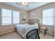 Bedroom features neutral color scheme, ample windows, and unique plate art wall decor at 660 Delbridge Nw St, Atlanta, GA 30314