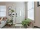 Entryway features a white door, plants, and neutral colored walls with wood floor at 660 Delbridge Nw St, Atlanta, GA 30314