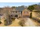 An aerial shot of a brick home with a well-maintained lawn and a long driveway in a wooded neighborhood at 4215 Idlewood Dr, Cumming, GA 30040